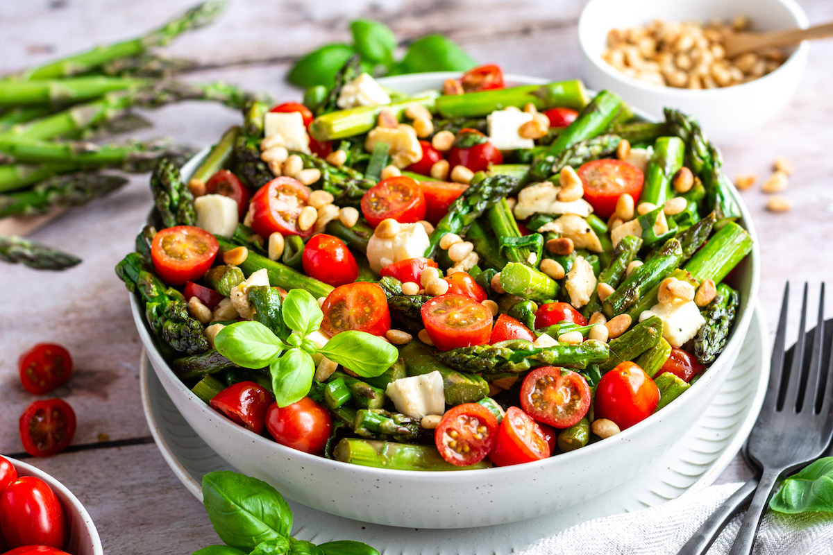 Asparagus salad with tomatoes, mozzarella, scallions and pine nuts.