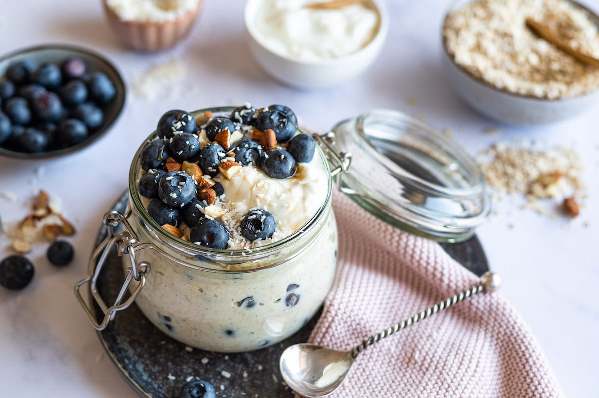 Blueberry Overnight Oats with Yogurt served in a glass jar.