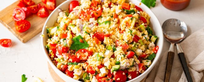 Bulgur Salad with Feta Cheese, bell pepper, tomatoes, and cucumber in a white bowl.