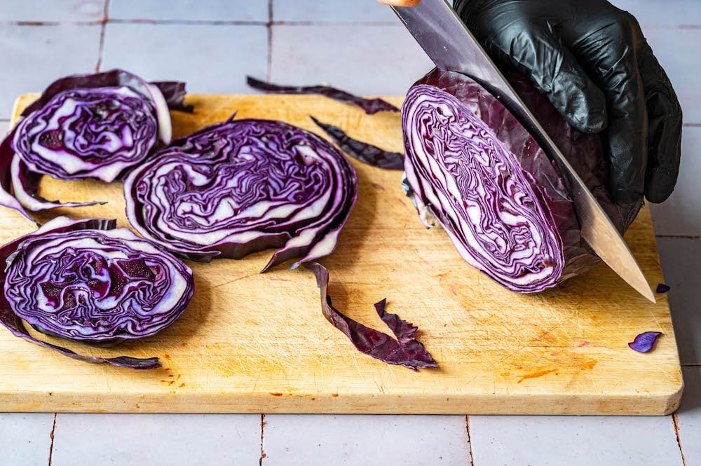 Cutting red cabbage into thick slices.