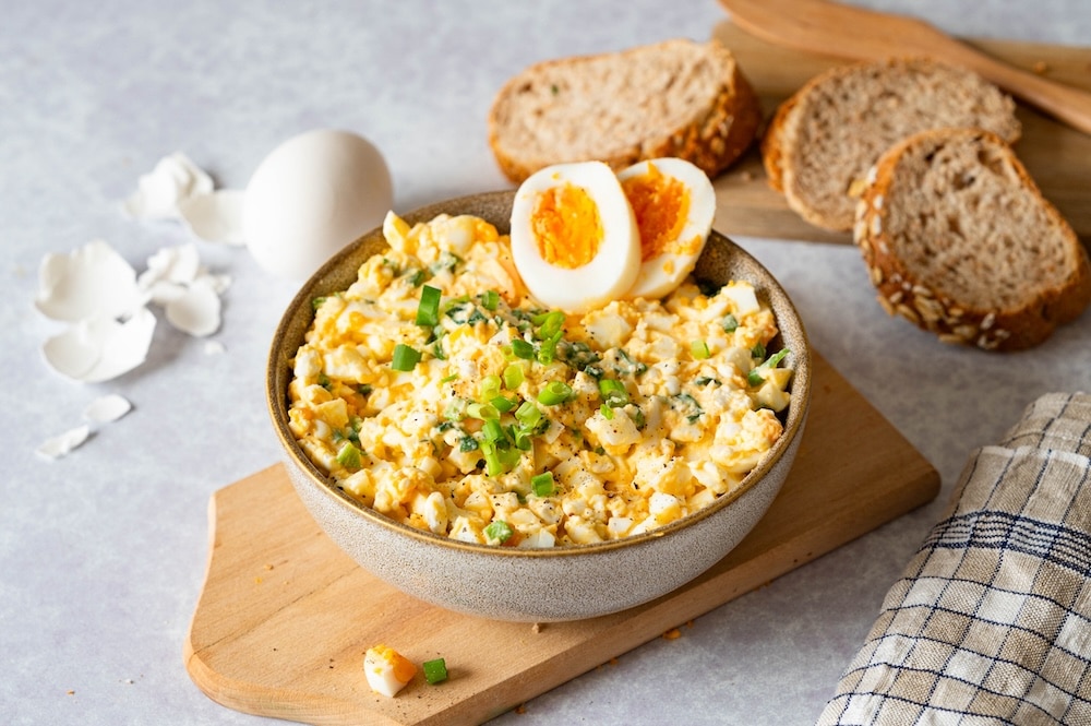 Egg Salad with Cottage Cheese served in a bowl and decorated with hard-boiled eggs.
