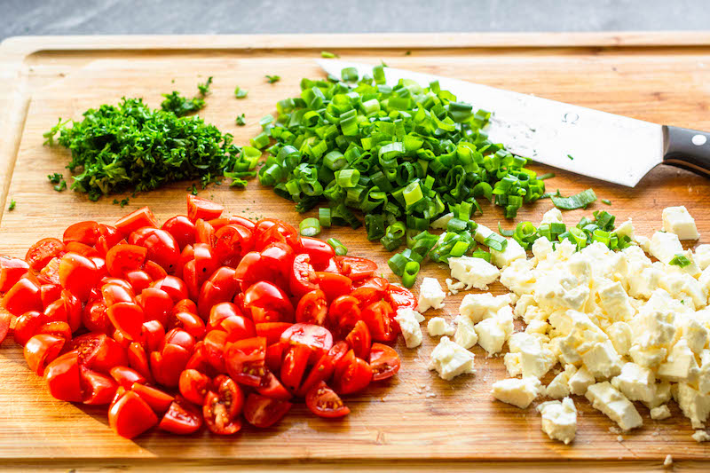 Cherry tomatoes, feta cheese, scallions and parsley cut into small pieces.