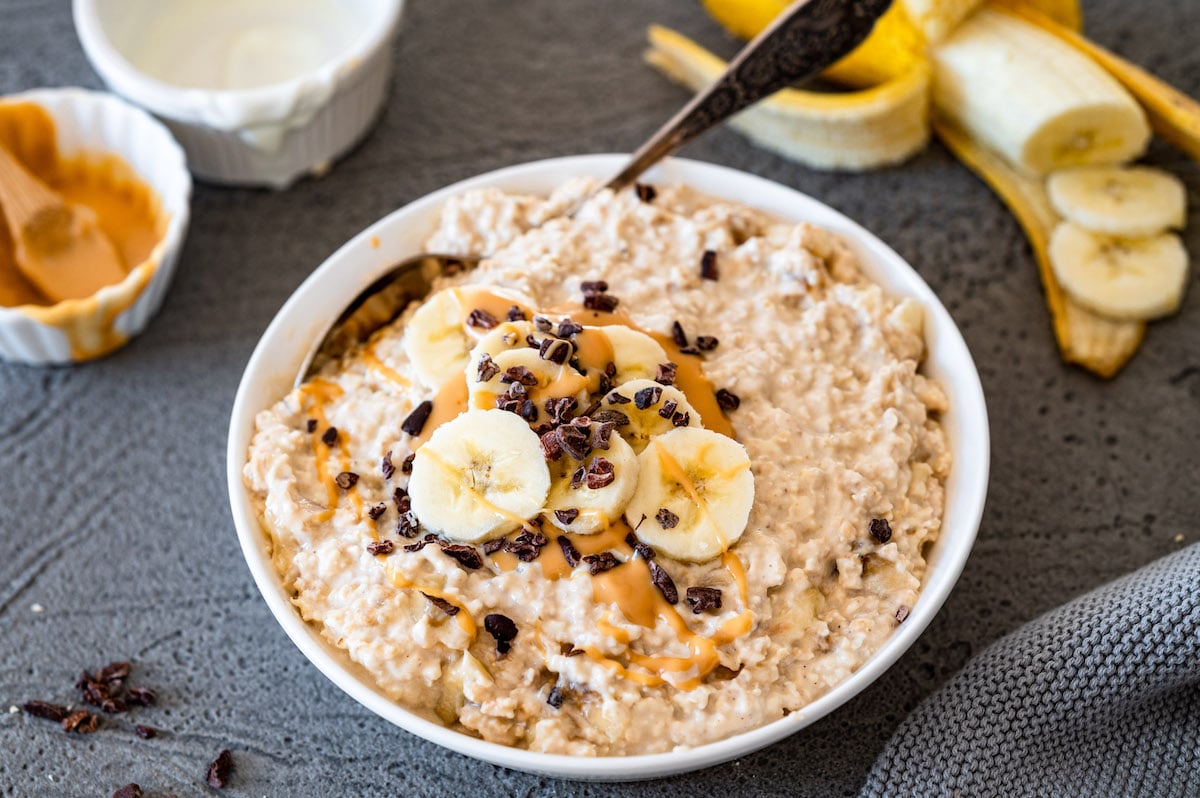 Overnight Oats with Peanut Butter, Banana, and Greek Yogurt decorated with banana slices and creamy peanut butter.