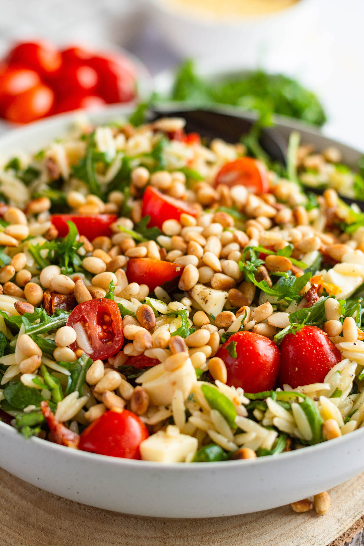 Risoni pasta salad with orzo pasta, tomatoes, arugula, mozzarella cheese, sun-dried tomatoes and roasted pine nuts.