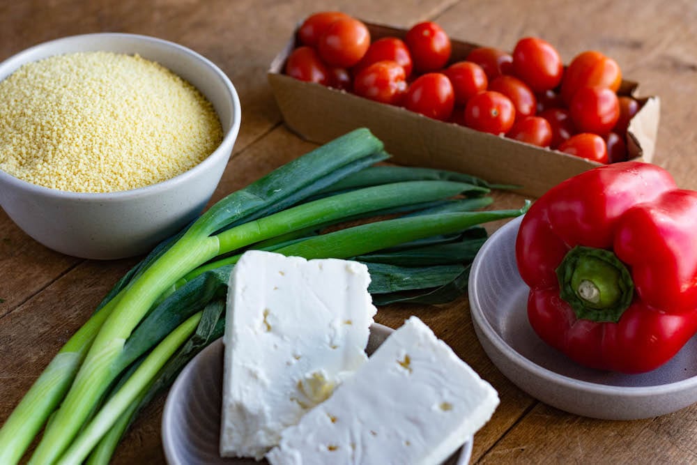Main ingredients for the couscous salad: Couscous, feta cheese, tomatoes, bell pepper and spring onions.
