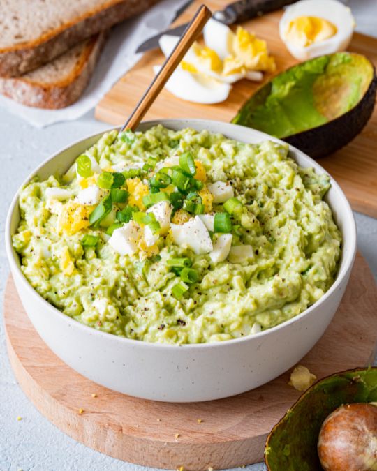Healthy avocado egg salad without mayo in a white bowl.