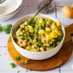 Potato broccoli curry with chickpeas and coconut milk served in a bowl.