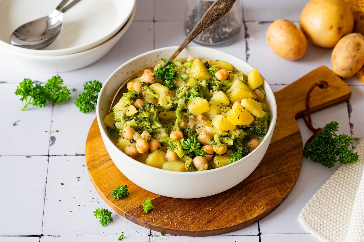 Potato broccoli curry with chickpeas and coconut milk served in a bowl.